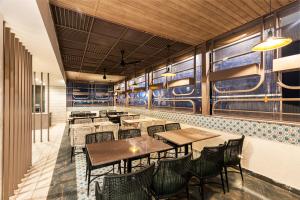 a restaurant with tables and chairs and a train mural on the wall at Narthaki Boutique Hotel in Bangalore
