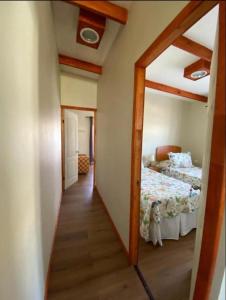 a hallway leading to a bedroom with a bed at Cabaña y Depto Puclaro in Vicuña