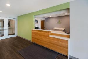 WoodSpring Suites East Lansing - University Area في إيست لانسنغ: غرفة مع صالون للشعر مع مرآة