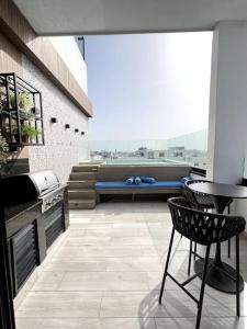 a patio with a bench and a table and a chair at Downtown Santo Domingo Luxury Apartment in Santo Domingo