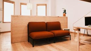 a chair with an orange seat in a room at guesthouse by good neighbor in Baltimore