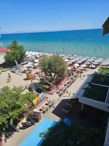 an aerial view of a beach with umbrellas and people at Studio Just On The Beach in Paralia Katerinis