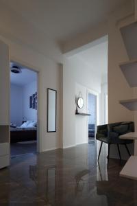 a room with a table and a clock on the wall at MC Centar Apartman in Pula