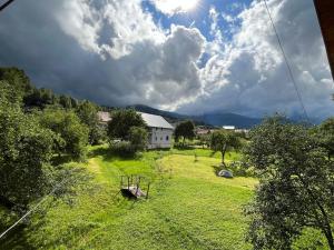 a view of a field with a swing at Beautiful house in Pilipets