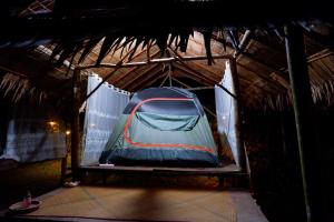 a tent is set up in a building at Khao Sok Hill Top Resort in Khao Sok