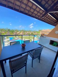 a blue table and chairs on a balcony with a view at Eco resort Praia dos Carneiros in Praia dos Carneiros