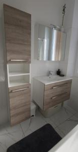 a bathroom with a sink and a toilet and a mirror at MC Centar Apartman in Pula