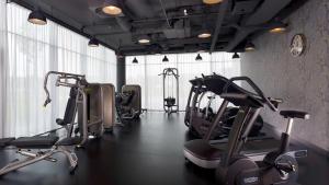 a gym with several cardio machines in a room at Park Plaza Amsterdam Airport in Lijnden