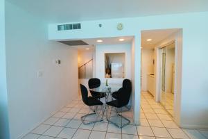 a dining room with a table and black chairs at Oceanview studio - on beach, gym, bars, and free parking! in Miami Beach