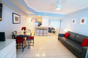 uma sala de estar com um sofá e uma mesa em Oceanfront condo with ocean view beach, bar, free parking and gym! em Miami Beach