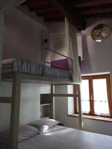 a bedroom with two bunk beds and a window at Casa Renacci in Subbiano