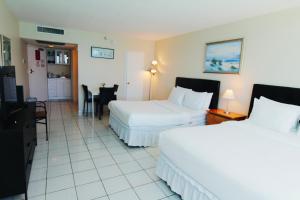 A bed or beds in a room at Castle 1733 Ocean view studio with direct beach access, pool, tennis & free parking