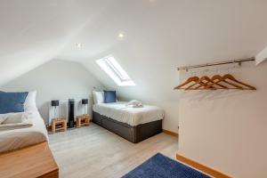 a attic bedroom with a bed and a couch at Dogwood in Salisbury