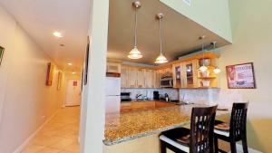 a kitchen with a counter and a table and chairs at Castle B17 Contemporary Condo with Pool, Beach Access and Free Parking in Miami Beach