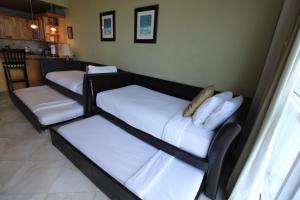 a living room with two beds and a kitchen at Castle B17 Contemporary Condo with Pool, Beach Access and Free Parking in Miami Beach