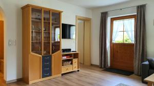 a large wooden cabinet in a living room with a window at Haus Habit in Schruns