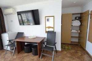 a dining room with a table and chairs in a room at ADONIS Costinesti in Costinesti