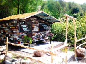 a small log cabin with a porch and a deck at Sweet Home Garda Lake in Provaglio Val Sabbia