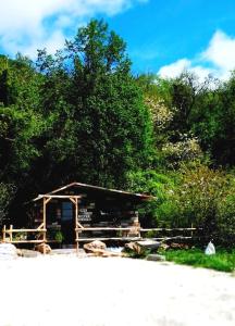 a small building on the side of a beach at Sweet Home Garda Lake in Provaglio Val Sabbia