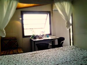 a room with a table and chairs and a window at Sweet Home Garda Lake in Provaglio Val Sabbia