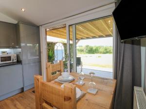 a kitchen and dining room with a table and chairs at Birch in Swadlincote