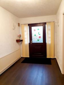 an empty room with a door and a window at Chimes-Company & Family Stay, 2 Bedroom House + Free parking in Tamworth