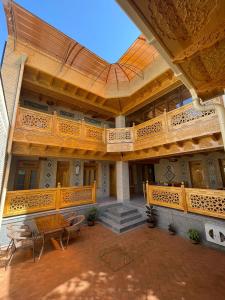 a building with a porch with a wooden roof at Hanifa Boutique Hotel in Samarkand