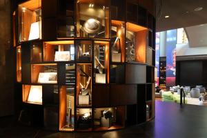 a room with a wall with a display of objects at The WB Abu Dhabi, Curio Collection By Hilton in Abu Dhabi