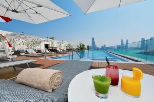 a table with drinks on top of a building at Hilton Garden Inn Bahrain Bay in Manama