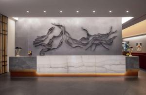 a lobby with a wall with a sculpture of two women at Hilton Beirut Downtown in Beirut +76 photos