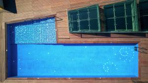 a building with a swimming pool and two windows at Hilton Beirut Downtown in Beirut