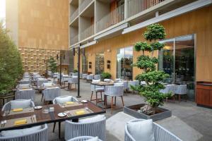 a restaurant with tables and chairs in a courtyard at Hilton Beirut Downtown in Beirut