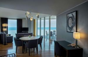 a living room with a table and chairs and a living room at Hilton Beirut Downtown in Beirut