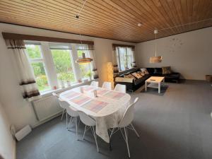 a living room with a table and a couch at The Yellow House, Beach 5mins Drive, 3BR with free parking, Fast Fiber Internet in Rødby