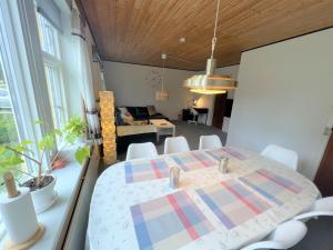 a dining room and living room with a table at The Yellow House, Beach 5mins Drive, 3BR with free parking, Fast Fiber Internet in Rødby