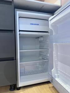 an empty refrigerator with its door open in a kitchen at Loft Nut con Estilo - Excelente Ubicación in Sabaneta