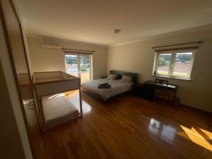 a bedroom with a bed and a desk in it at Amazing Scorpion´s House Leiria in Leiria
