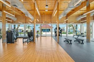 a gym with wooden ceilings and a large room with benches at Fuwairit Kite Beach, Tapestry Collection By Hilton in Fuwayriţ