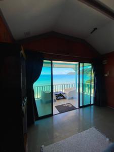 a living room with a view of the ocean at Pondok Beach Shack in Tioman Island