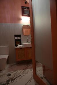 a bathroom with a sink and a toilet at PhiloXenia Traditional Apartments in Chios