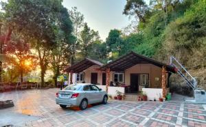 a car parked in front of a house at KATAKERI HOLIDAY HOME in Madikeri