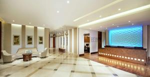 a lobby with a large window in a building at Hilton Garden Inn Dubai Al Mina - Jumeirah in Dubai