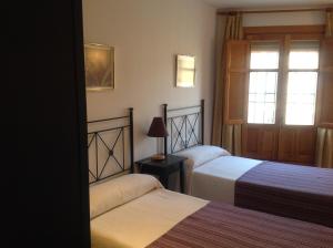 Postel nebo postele na pokoji v ubytování Alojamientos Turísticos Casco Antiguo