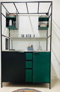 a kitchen with a green counter and a sink at BEST VIEW in the Heart of Kosice in Košice