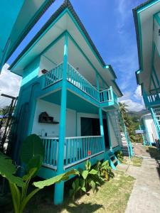 a blue house with a balcony at Pondok Beach Shack in Tioman Island