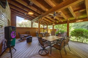 a screened porch with a table and chairs and a tv at 7 Mi to Beech Mountain Skiing Home with Fire Pit in Banner Elk