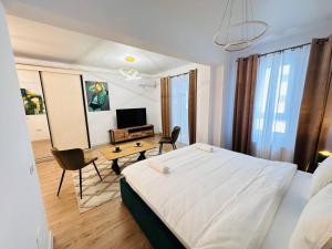 a bedroom with a bed and a desk and a television at RHUM B02 - Liberty in Bucharest