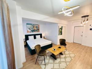 a bedroom with a bed and a table and chairs at RHUM B02 - Liberty in Bucharest