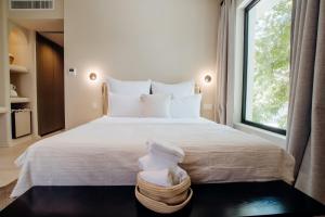 a bedroom with a large bed with towels on it at Thymises Boutique Hotel in Kakopetria
