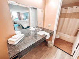 a bathroom with a sink and a mirror at Laker Inn in Jamestown